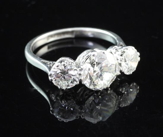 A platinum and three stone diamond ring, size M.